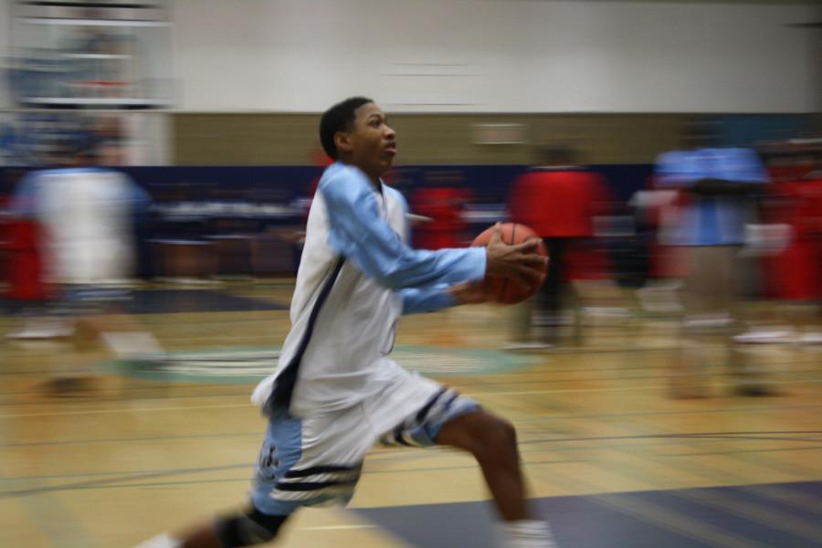 Senior Tim Patrick flies down the court at a home game.