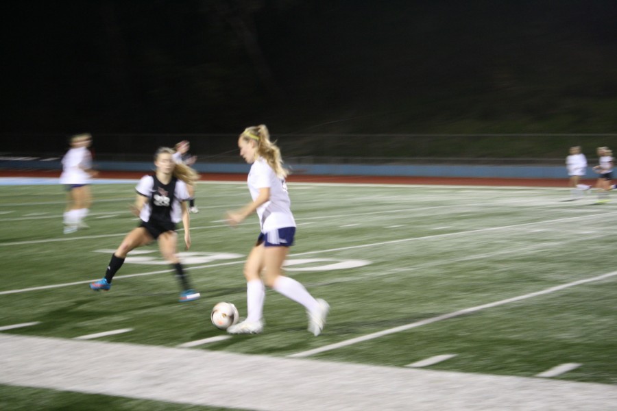 Junior Emelia Owen sprints past an imposing defender from La Jolla High.