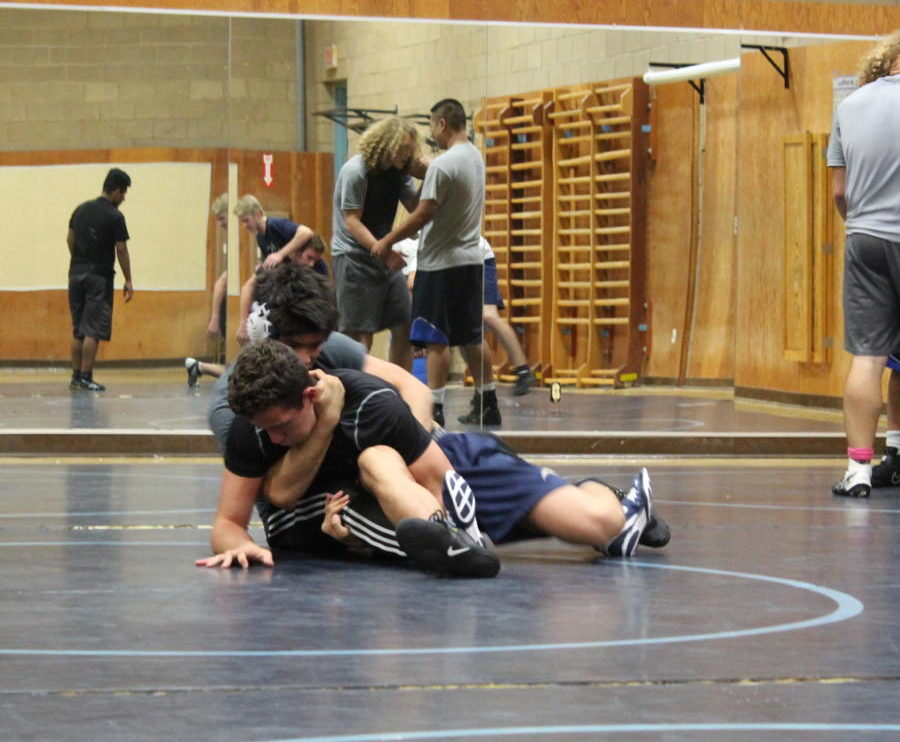 Senior Sean Gonzalez puts Senior Eddie Roa in a submission hold. 