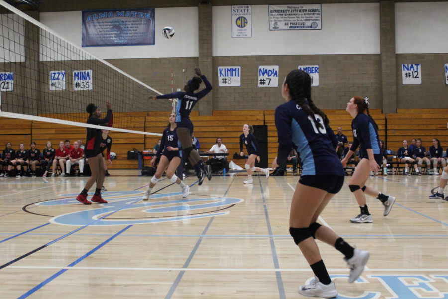 Senior Nicole Vincent goes up to hit the set from Senior Avalon Denecochea. Senior Cassy Goldenstein and Juniors Izzy Milles and Victoria Rednoske run in to cover the ball. 