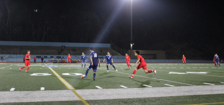 Senior Sage Corona passes the ball to a waiting teammate.