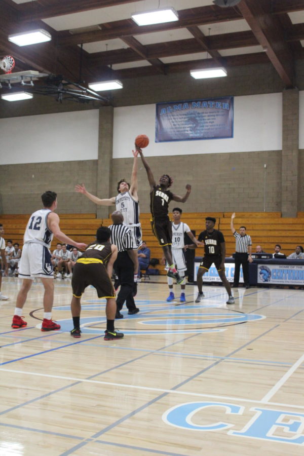 Junior Benito Hurtado goes up for the tip-off against Serra High. 