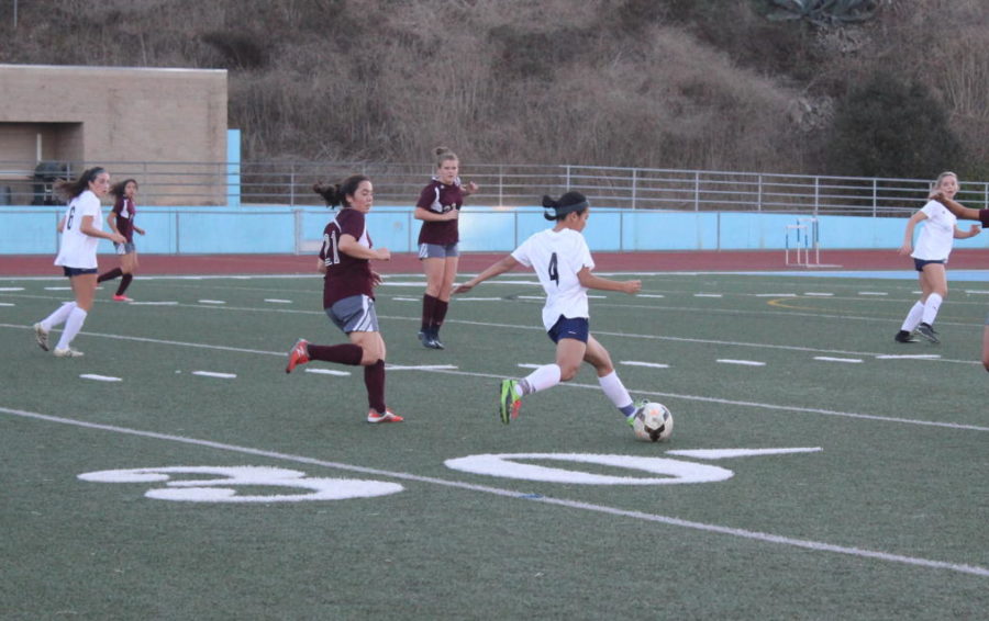 Senior Allison Bush prepares to pass the ball up the field.