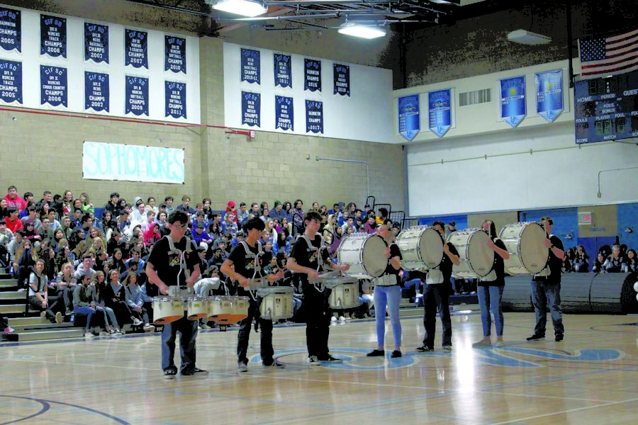Fall Drumline Members Michael Haley, Alex Tong, Jeff Livers, Emily Pilkington, Anthony Dinh, Cassandra Bristol and Benji Davis, some of whom are in Winter Percussion, perform at the Winter Pep Rally. 