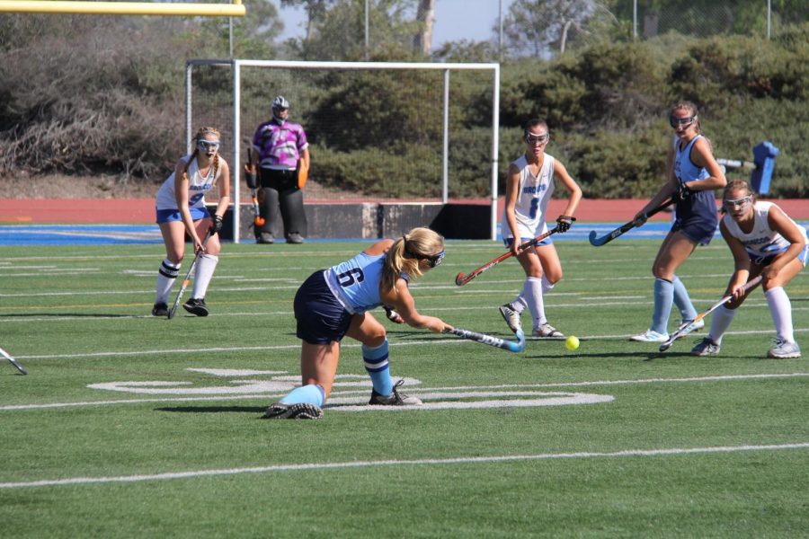 Midfielder Senior Olivia Upham makes a pass to Midfielder Junior Angela Cook in a pre-League game against Rancho Bernardo High in the 2019-2020 season.

