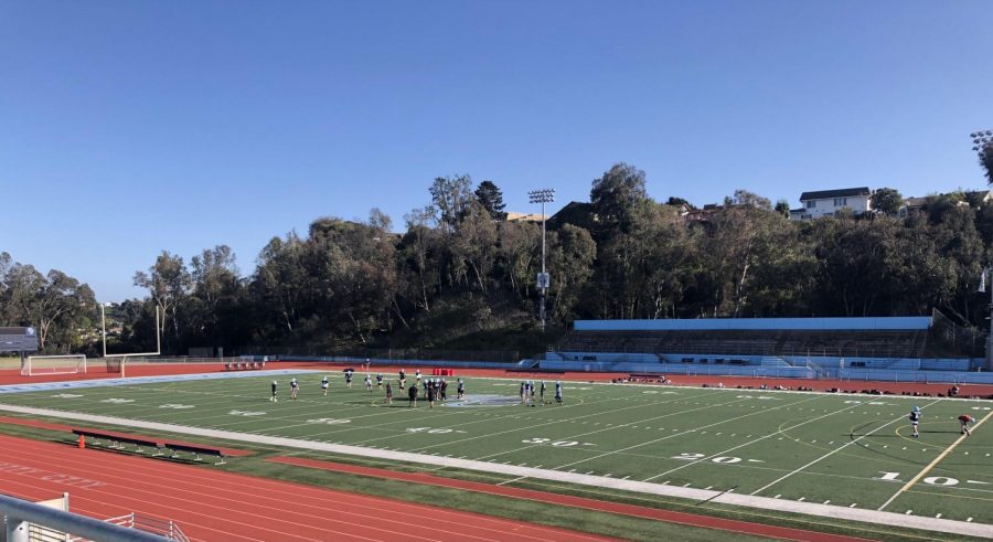 The UC High Football Team practicing in the stadium.