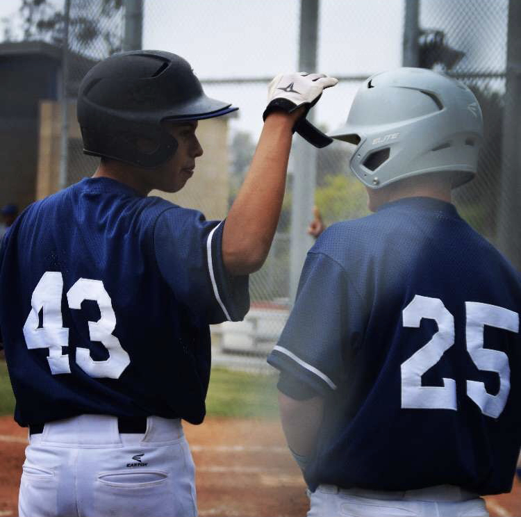 Seniors Alonzo Ramos and Gavin Scurr congratulate each other during a practice.