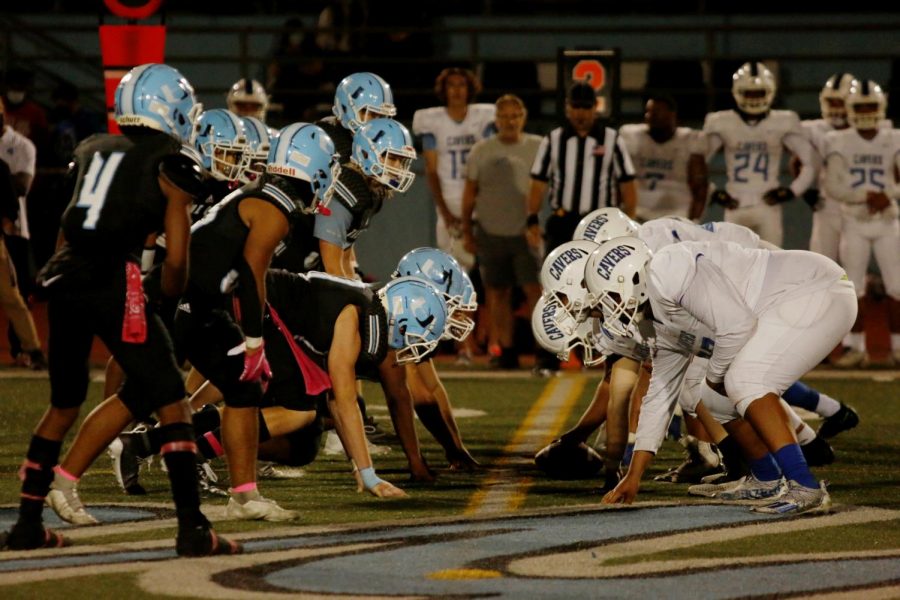 The UC High football defense prepare to stop the San Diego High Cavers.