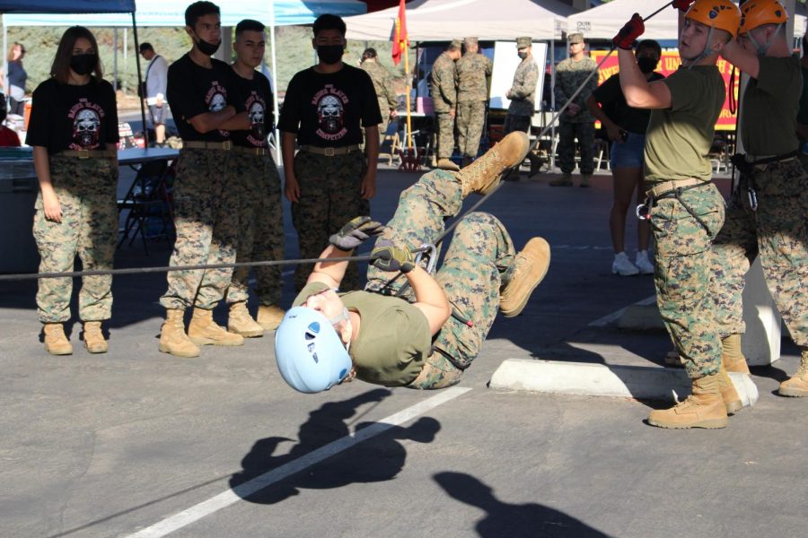 Senior Miranda Figueroa crosses a rope bridge constructed during JROTC building contest.