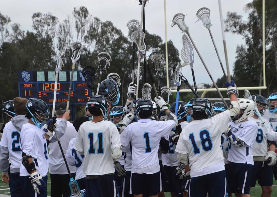 The+UC+Boys+Lacrosse+Team+raise+their+sticks+to+get+pumped+to+finish+their+game.