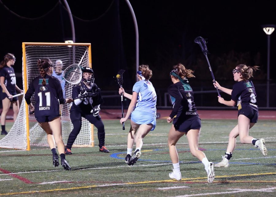 Sophomore Grace Doolittle shooting a goal againts five defenders at Sage Creek High.