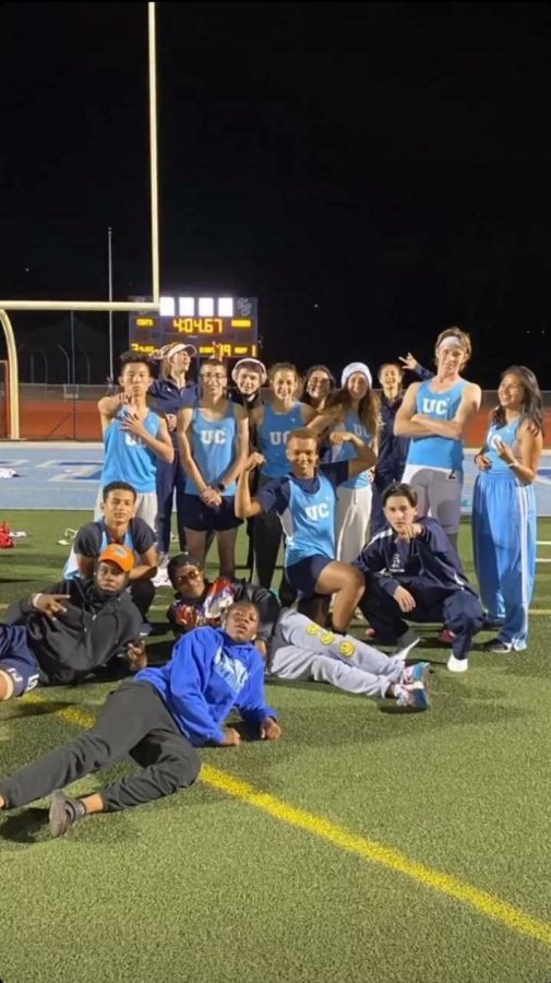 UC Track Team posing for a team photo after victory.