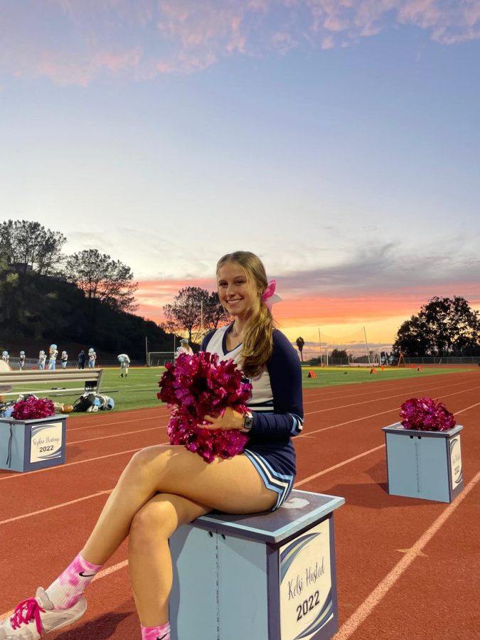 Senior+Kelsi+Husted+posing+for+a+picture+during+a+football+game.