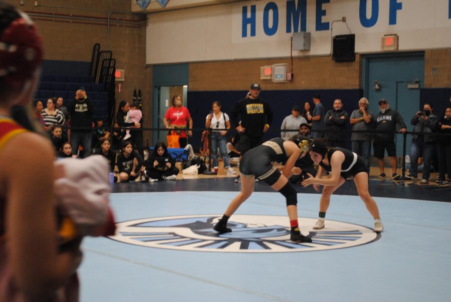 Junior Brooke Candray facing her opponent on the mat in the school's gymnasium on December 3.