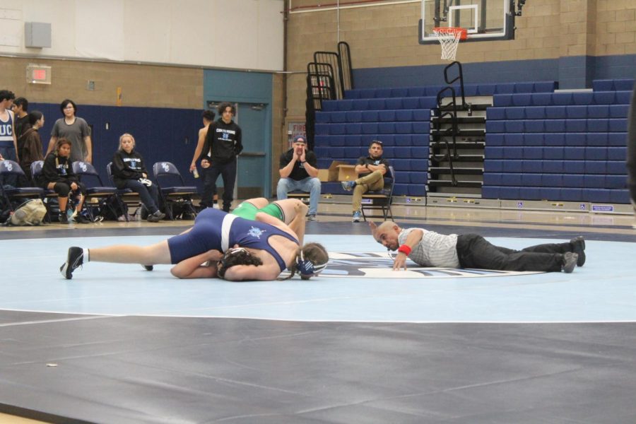 Sophomore Isaac Parker pins an opponent during a home match on Wednesday, November 30.