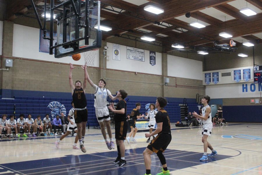 Junior Ben Gavani attempts a rebound during a non-League game against Point Loma.