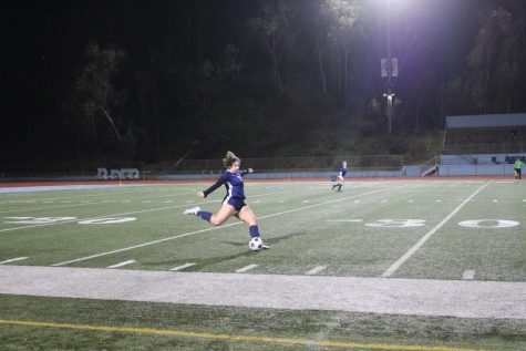Freshman Hayden Goldstein kicks the ball down the field against Our Lady of Peace.