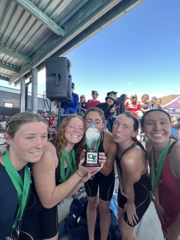 Swimmers Junior Tatiana Dorrestein, Molly Ryan, and Sophia Knowles, along with Senior Kathryn Hazle and Junior Corrie Dudley with their CIF trophy (left to right).