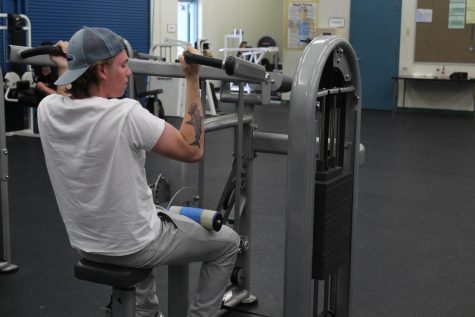 Senior Wyatt Lange using the old equipment in the weight room.
