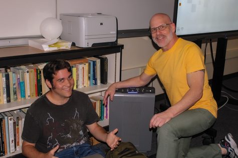 Mr. Mike Jason assists Student Nathan Fishman during class.