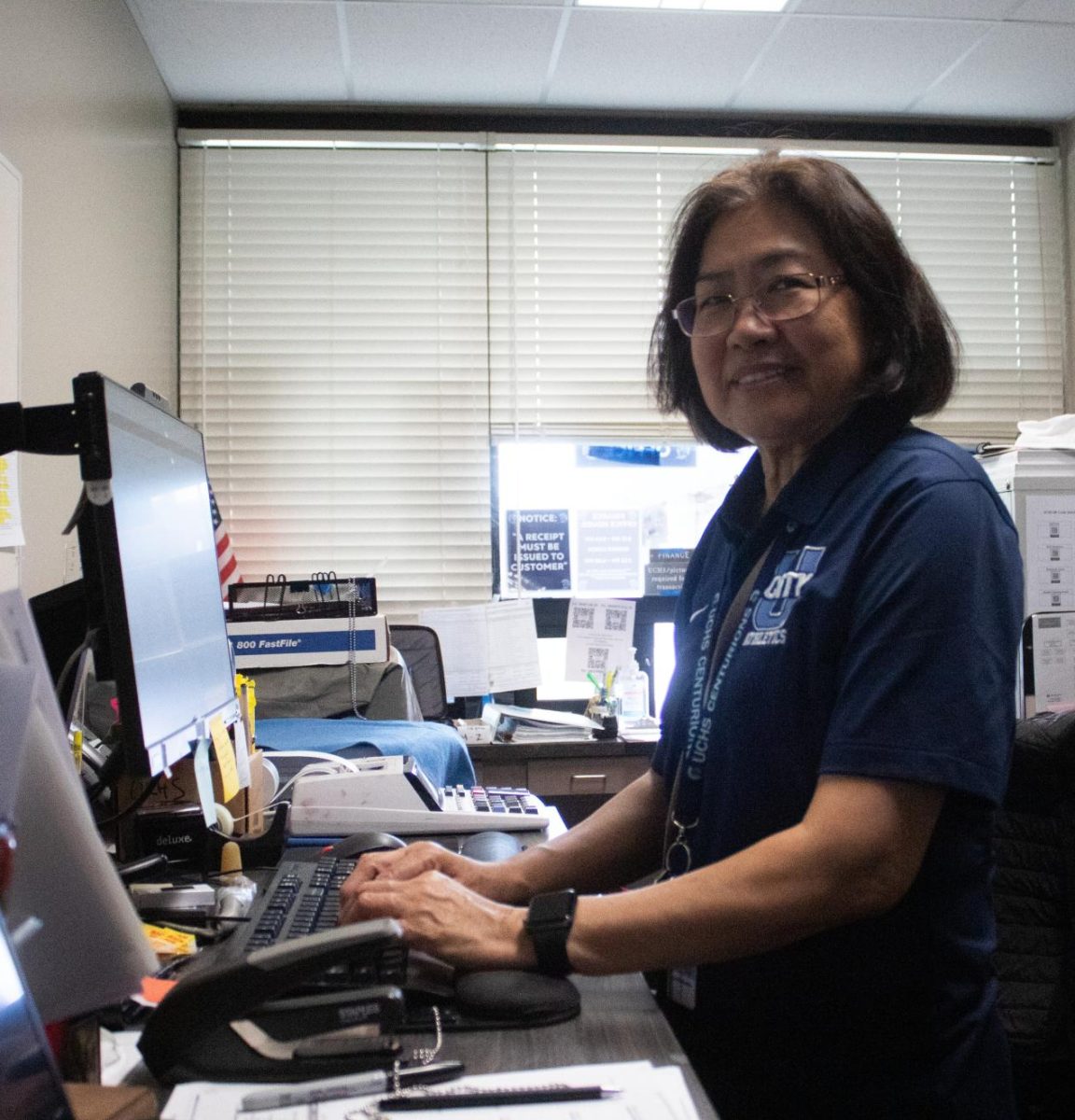 Senior High Financial Clerk Lucila Alonzo poses at her desk.