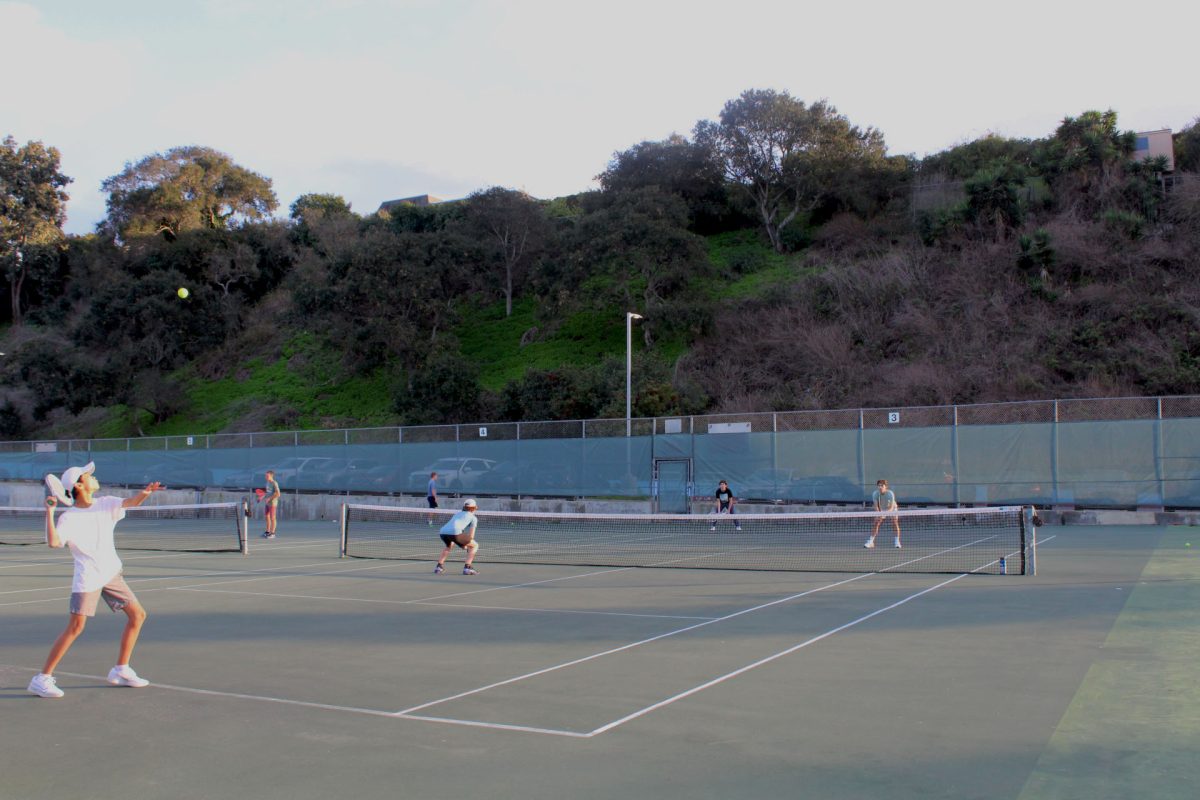 Freshman Noah Beppu serving in a practice match at the UC courts.