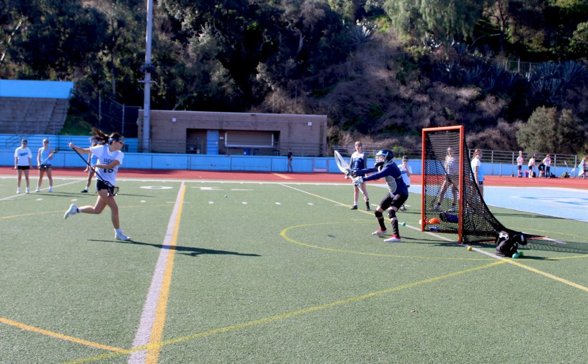 Junior Keira Roberts taking a shot on Senior Goalie Eliza Hudson at tryouts. 