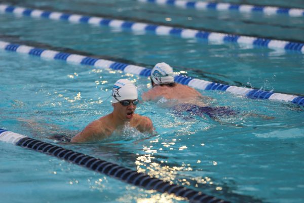 Senior Storme Higgins working on his breast stroke at a team practice.