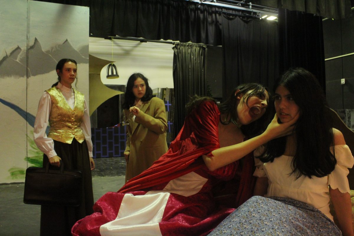 Students Siena Young, Elo Golynskiy, Magdelena Moran, and Liliana Munoz  (left to right) enact a scene from Dracula.