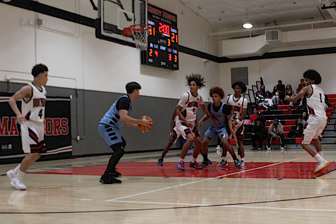 UC Boys Basketball fighting for the win at a game against Mount Miguel.